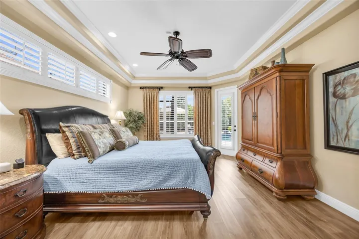 Primary bedroom with pedestrian door to back lawn oasis