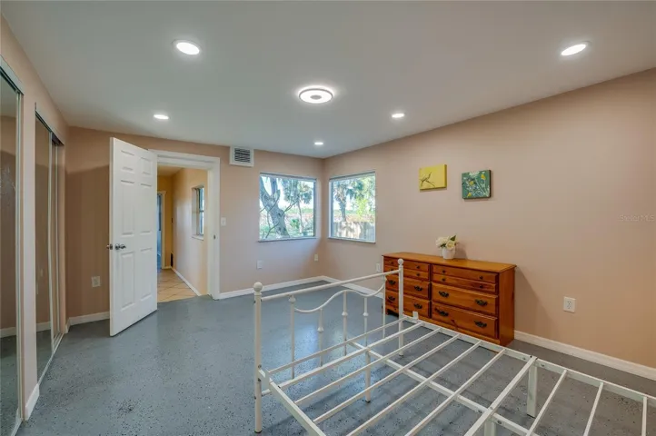 In-law Suite - Large bedroom with multiple windows for natural light and a bright, airy atmosphere. The layout provides ample wall space and room for furnishings.