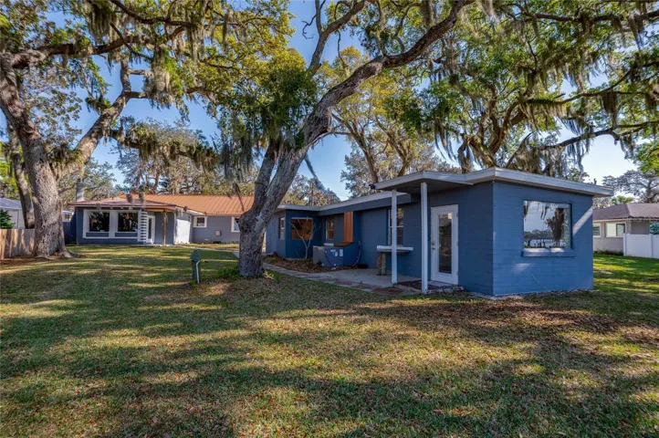 The in-law suite features a small covered porch area, and surrounding green space. The location offers privacy while remaining close to the main home.