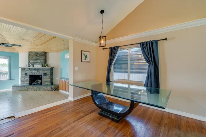 Dining space with wood floors, opens directly to the living room and fireplace. A great setup for casual meals or gathering with guests.