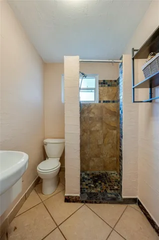 In-law Suite - Full bathroom with a tiled walk-in shower and practical layout designed for everyday function.