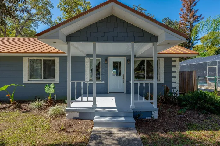 Inviting covered front porch with classic columns and a welcoming entry, adding charm and curb appeal to the home’s exterior.