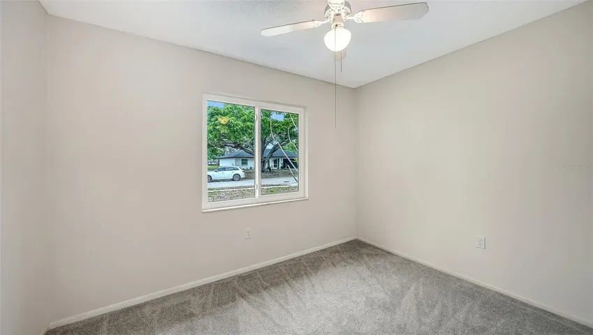 Bedroom 2 (new carpet) looks over the front yard