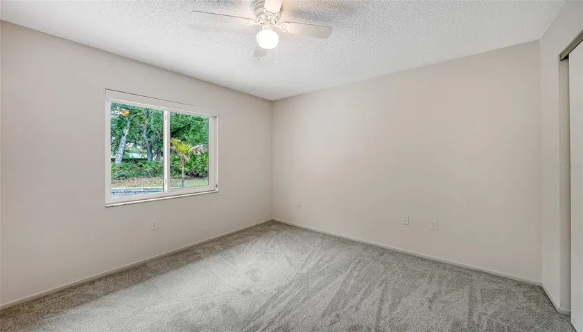 Primary bedroom looks out on the back yard