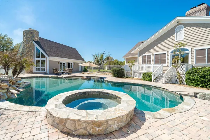 Pool area with hot tub