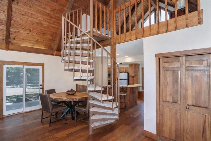 Spiral staircase leading to a cozy loft bedroom.