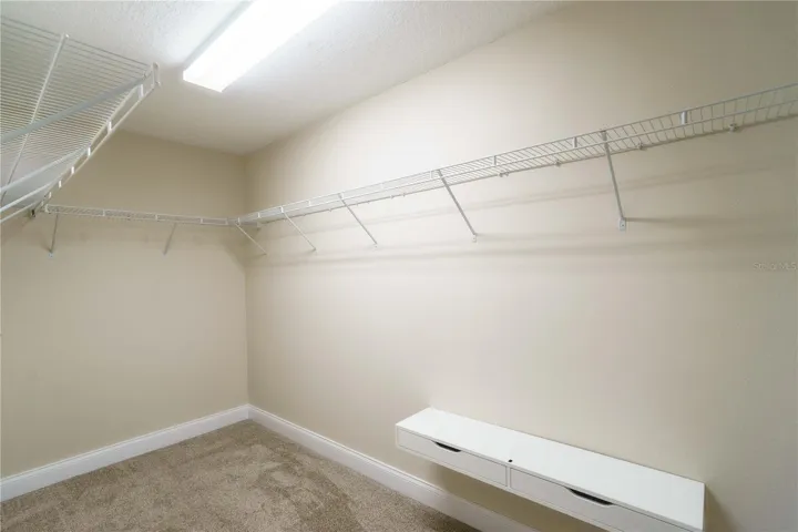 Walk in closet in primary bedroom