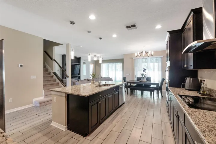 Kitchen with view of dining nook, stairs, and living area