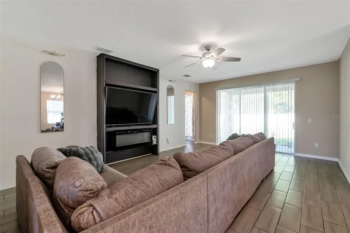 Living room with built in and oversized sliding glass doors