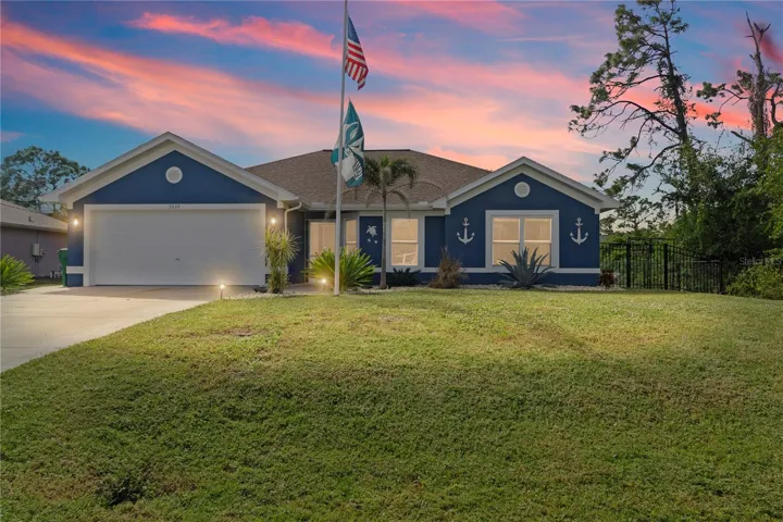 Ranch-style house with a garage, stucco siding, and concrete driveway