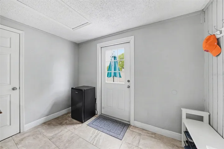 Mud room with access to back yard