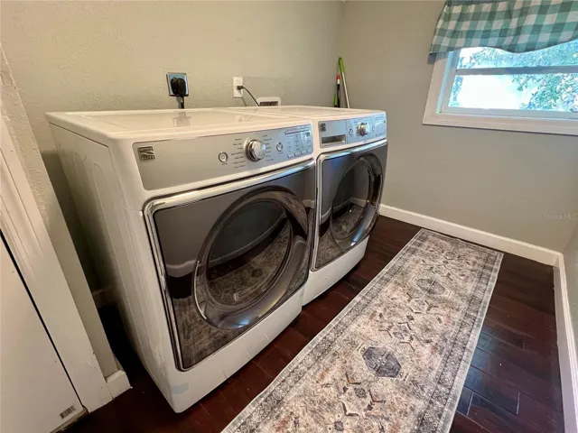 Wooden floors and full size washer and dryer make the laundry room complete.