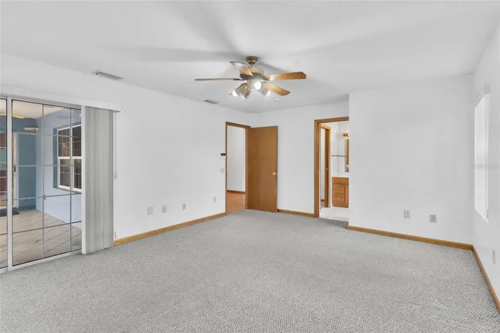 Primary suite with sliding doors to the lanai and pool