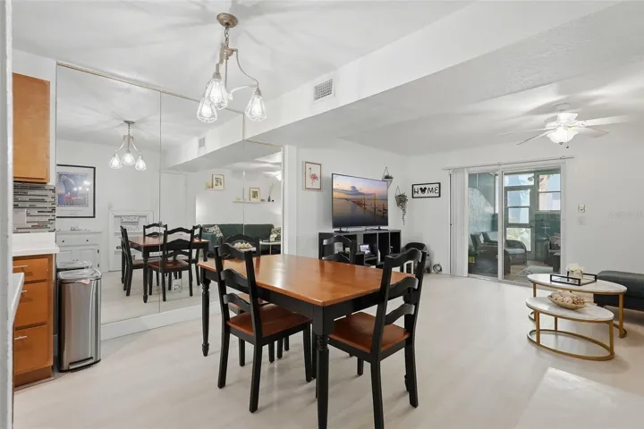 Open living space looks even larger with mirrored wall in dining area