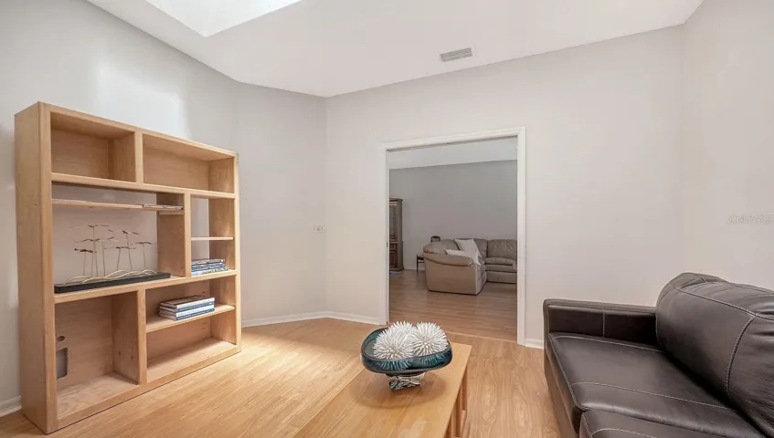 Large den has pocket doors for privacy and a skylight- rare for the Buttonwood model