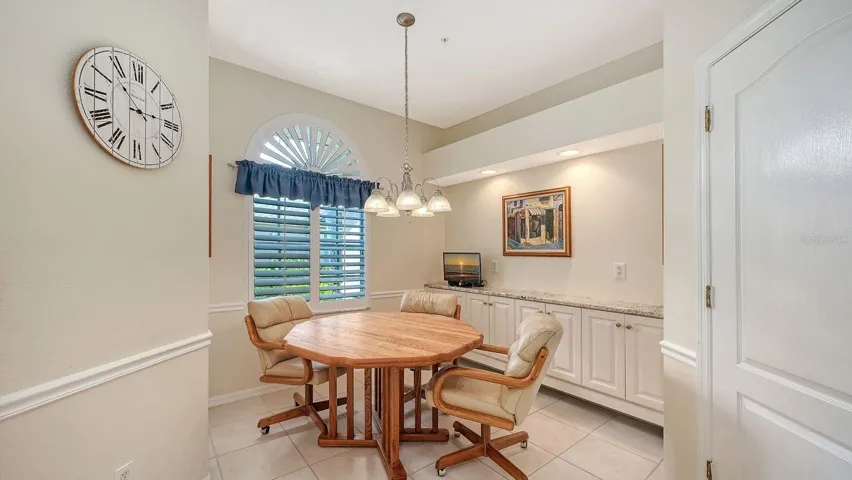 Eat in kitchen with built in buffet with slab granite countertops