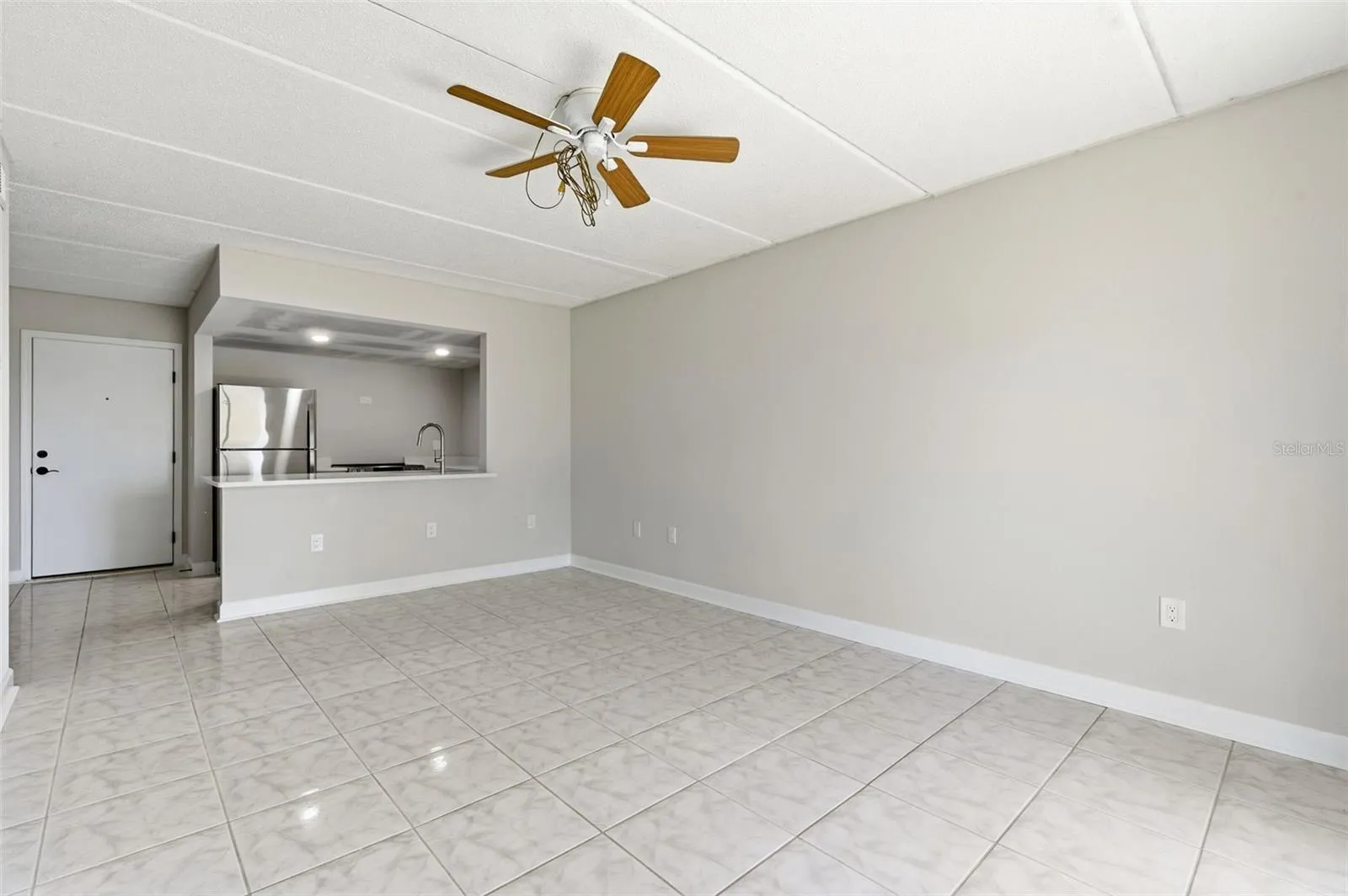 Entrance into condo with kitchen and living room