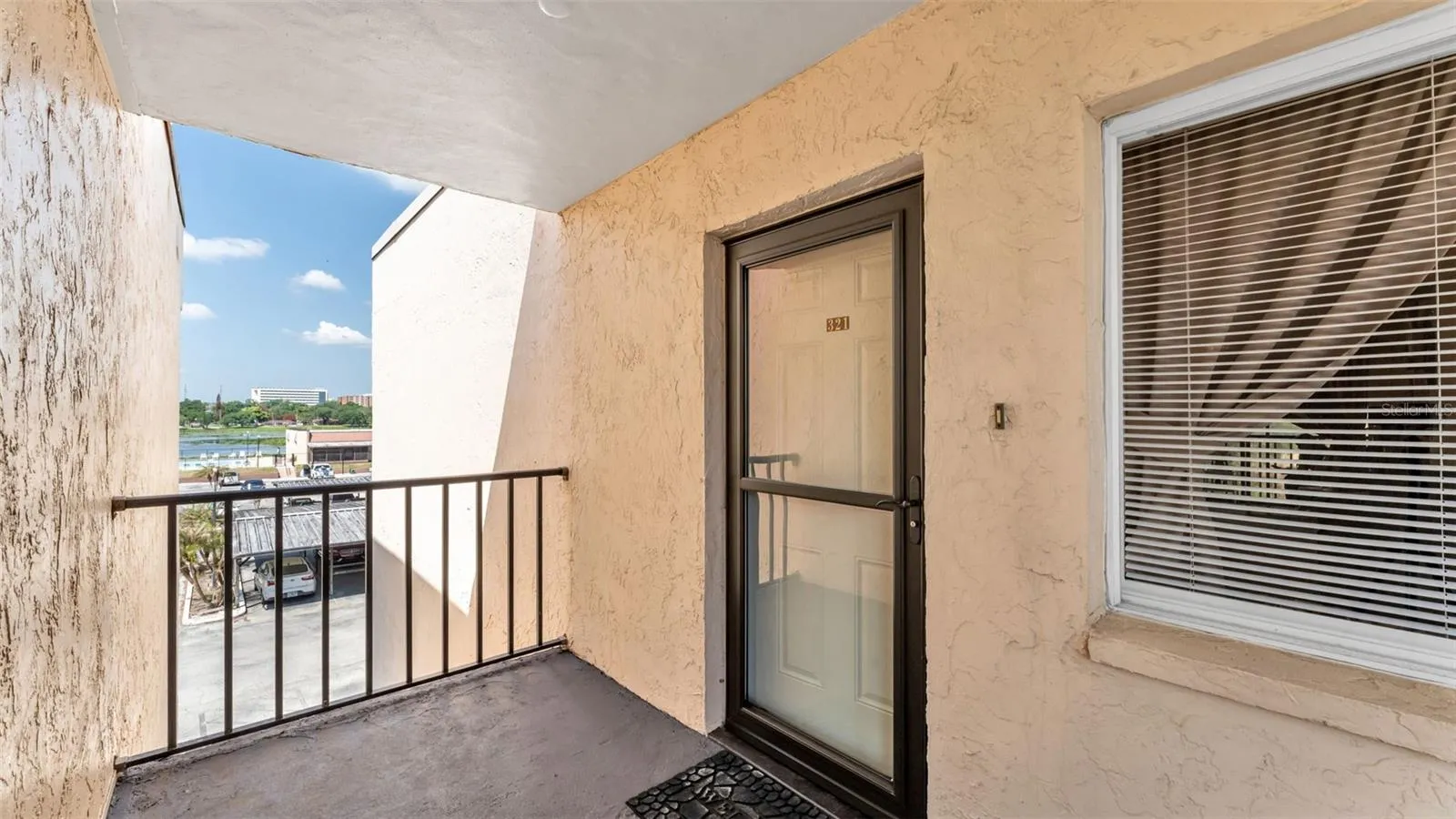 End unit with upgraded storm door that slides to allow a clear view to the exterior with breeze at the top.