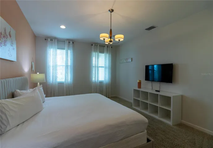 Bedroom 1- Master Suite: King bed, private bathroom, smart TV, Elegant decor, perfect for relaxing.