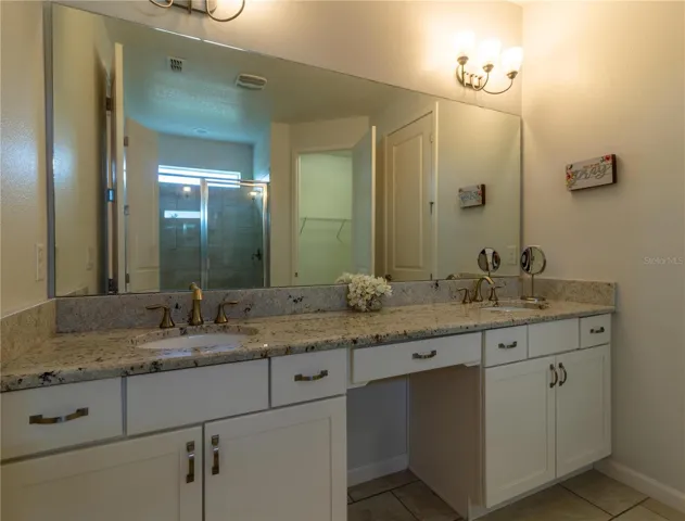 Bathroom 1- Master Suite: Private, en-suite bathroom with double vanity, large shower, and modern fixtures. Luxurius and spacious.