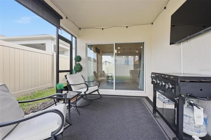Rear screened in porch for enjoying the game and grilling out