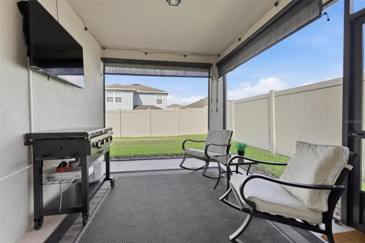 Rear screened in porch with sun shades for added privacy and sun filtering