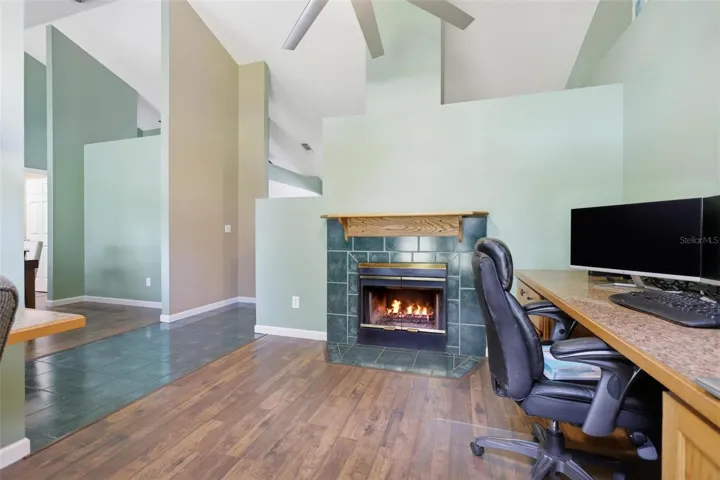 Den with built in desk and fireplace