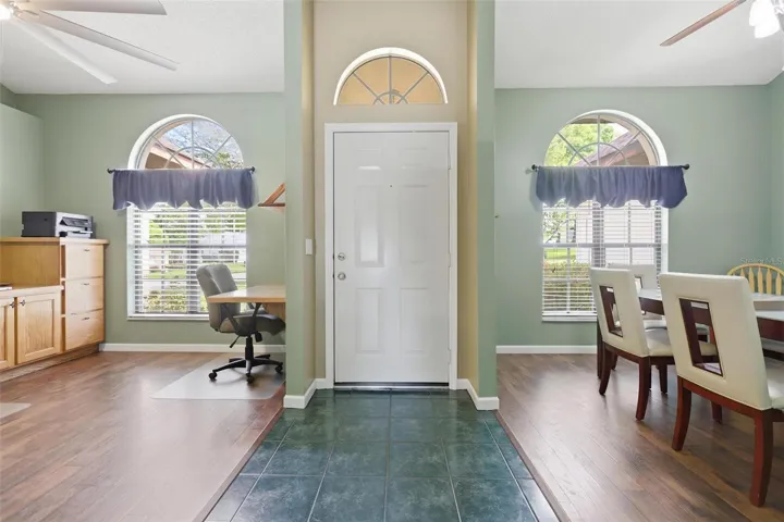 Entryway with dining room and den