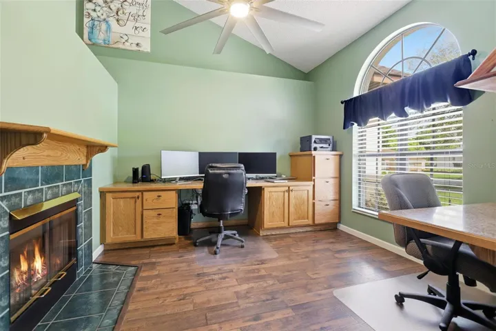 Den with built in desk and fireplace