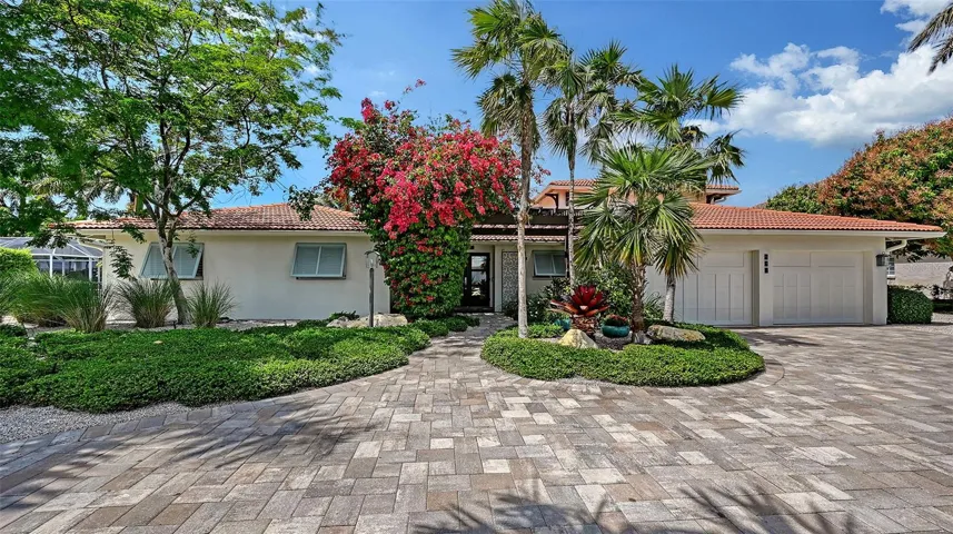 Circular driveway with mature palms and curb appeal