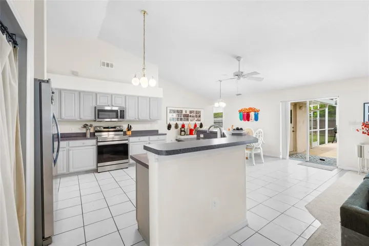 Kitchen view from Family Room with sliding glass doors to pool