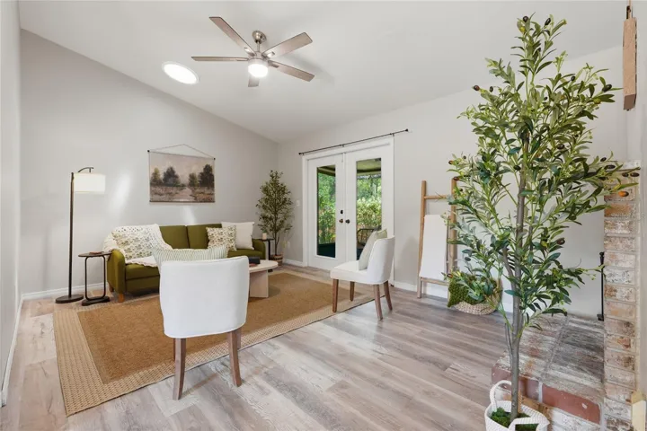Living Room with High Ceilings, FP & French Doors to Screened Patio