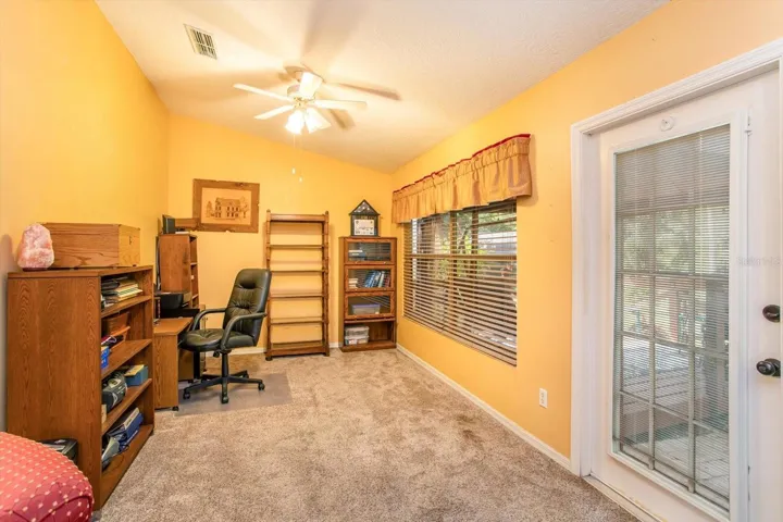 This Family Room is also being used as an office.  You can see through the french door towards the deck and gazebo.