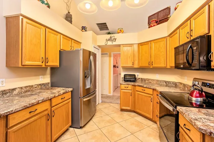 Beveled edged counters frame this quite functional kitchen newly updated with stainless appliances.