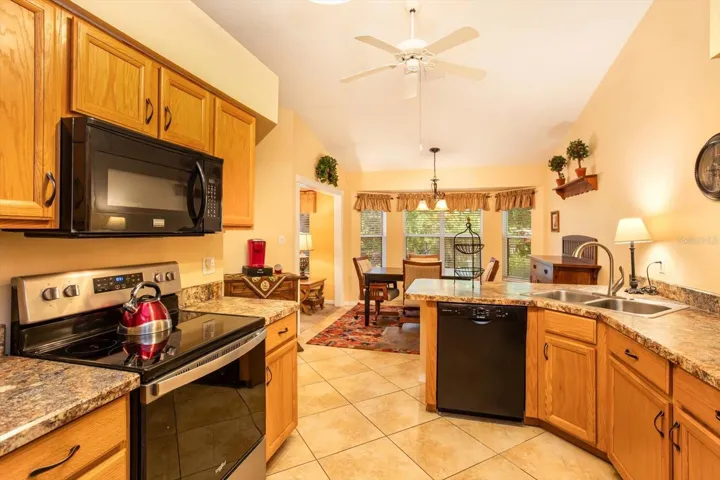 Kitchen opens up into a Breakfast Nook that is framed by a delightful bay window overlooking the expansive rear garden and green space.