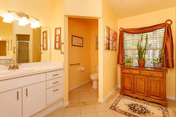 Privy has a comfort height toilet, and the opening has been renovated to widen it for easier access.  This is the second raised vanity.