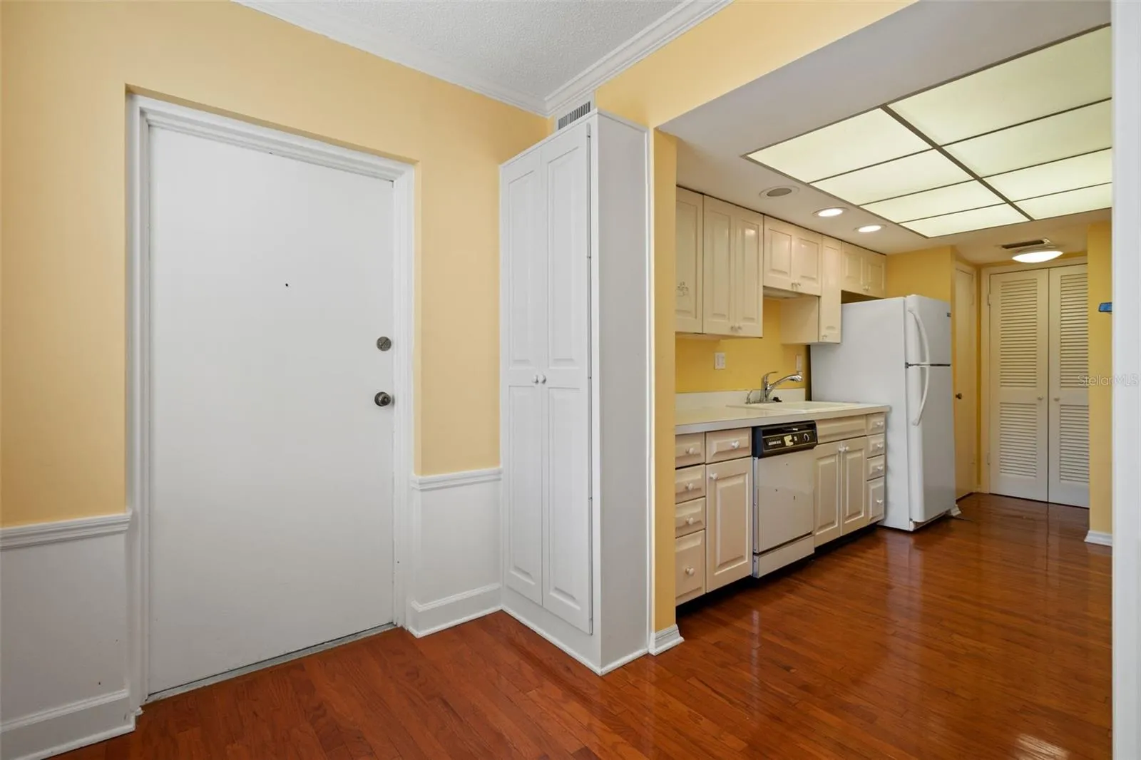 Kitchen eat in space with back door leading to laundry