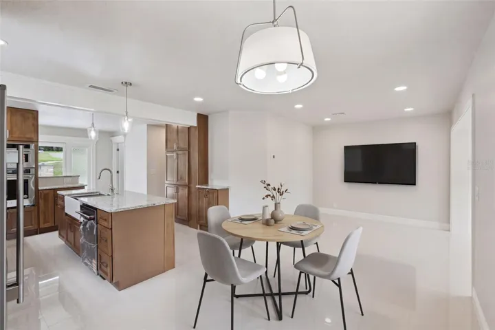 Virtually staged dining area overlooking family room