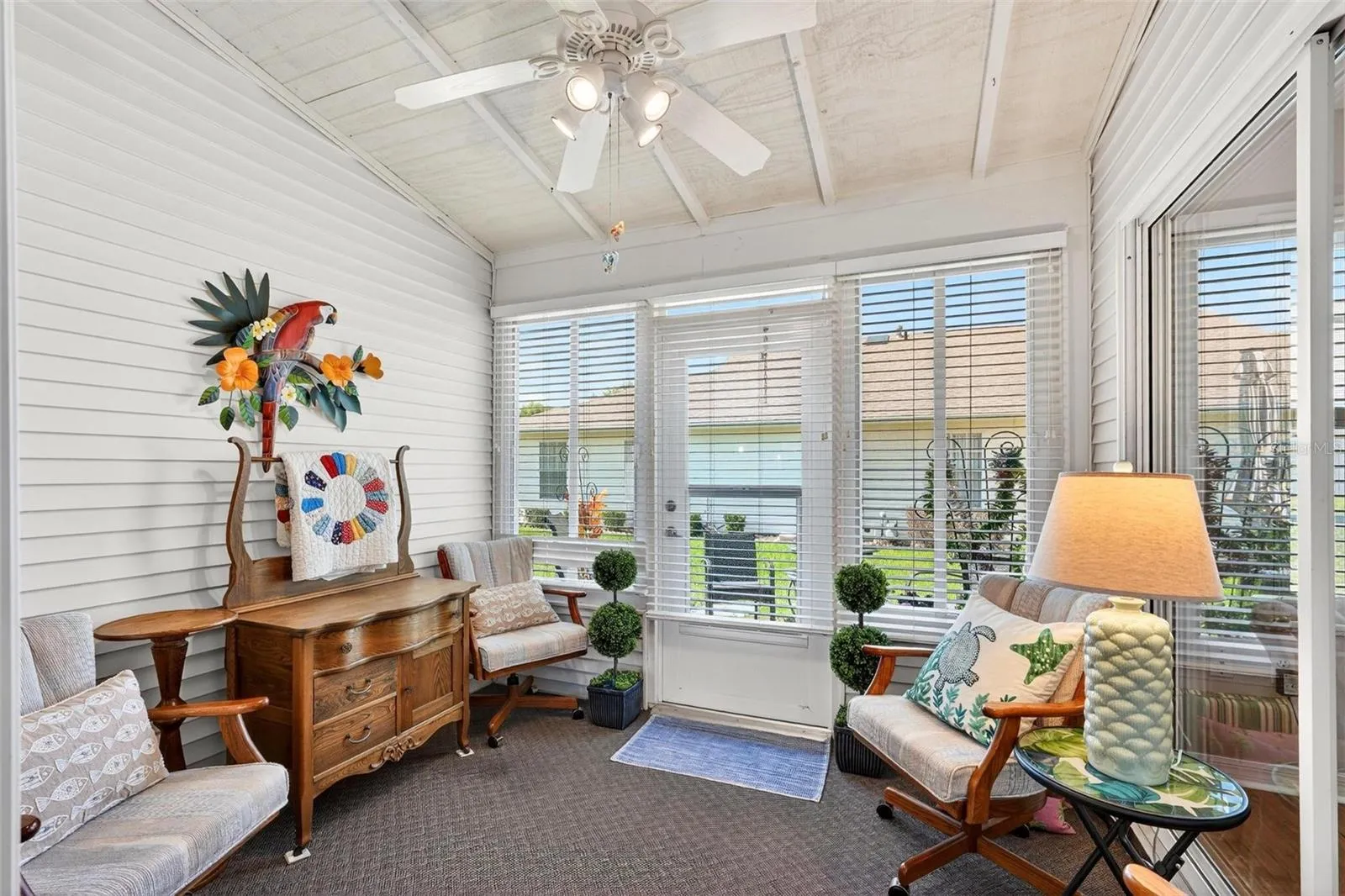 Florida room with ceiling fan and access from the living room and primary bedroom