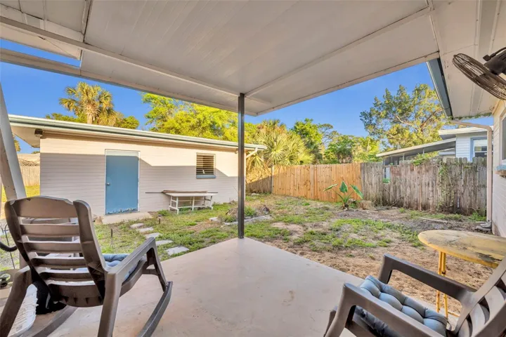 Patio facing detached garage.