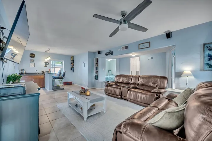 Family room facing kitchen entrance and guest room/bath entrances.