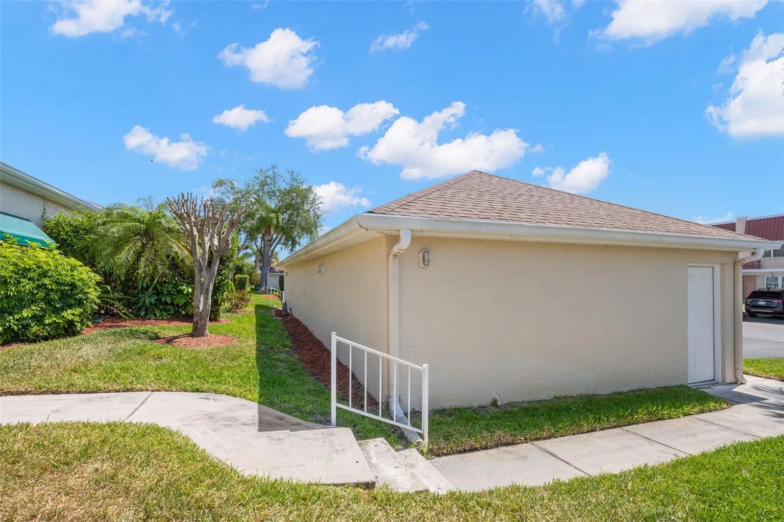 Front sidewalk with entry to detached garage.