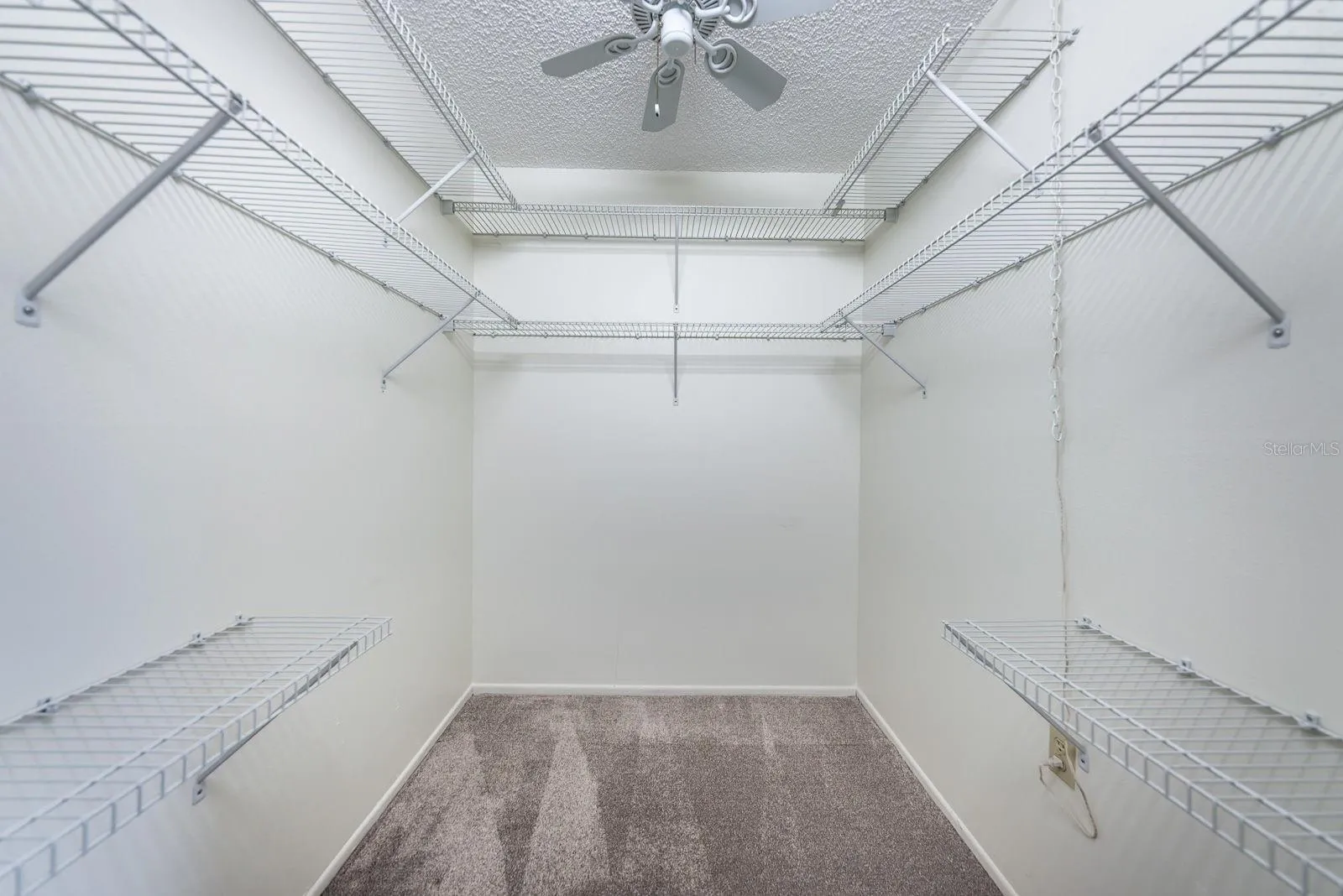 Walk in closet in primary bedroom
