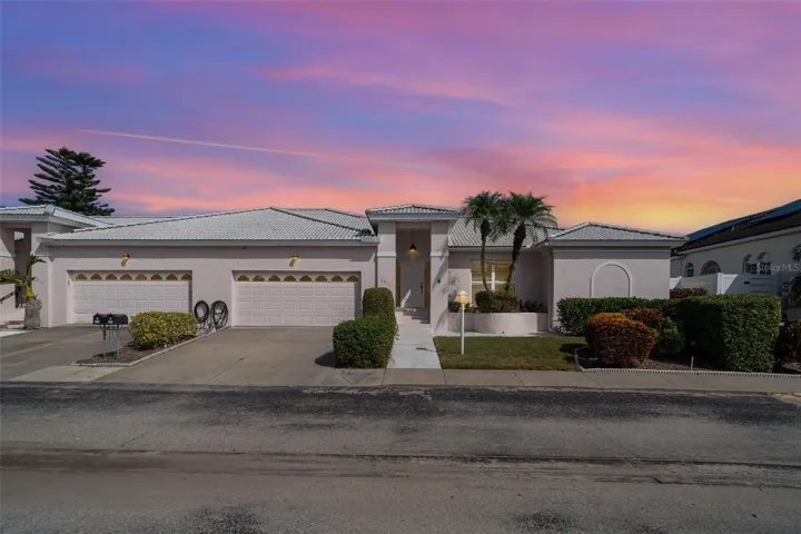 Stunning twilight exterior with excellent curb appeal, centrally located in Bradenton with easy access to IMG Academy and local Gulf beaches.