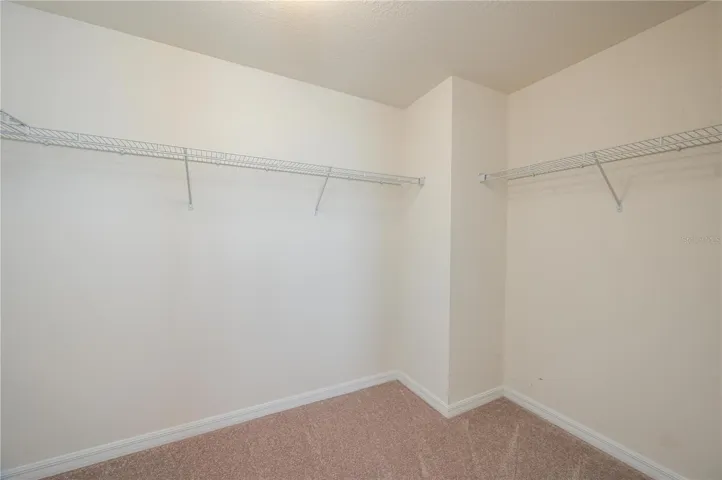 Walk-in closet with plenty of storage potential.