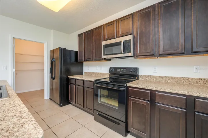 Open-concept kitchen is built for connection, featuring a center island, stainless steel appliances.