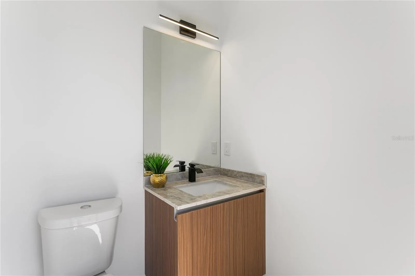 Convenient cabana half bathroom provides easy access from the pool area, perfect for guests and outdoor entertaining.