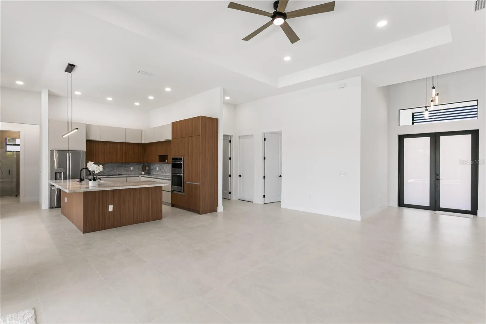 High-end finishes include MATTE PORCELAIN TILE throughout, IMPACT-RESISTANT Low-E windows & doors, BAHAMA SHUTTERS & a welcoming COLUMNED FRONT PORCH w/ frosted DOUBLE ENTRY DOORS.