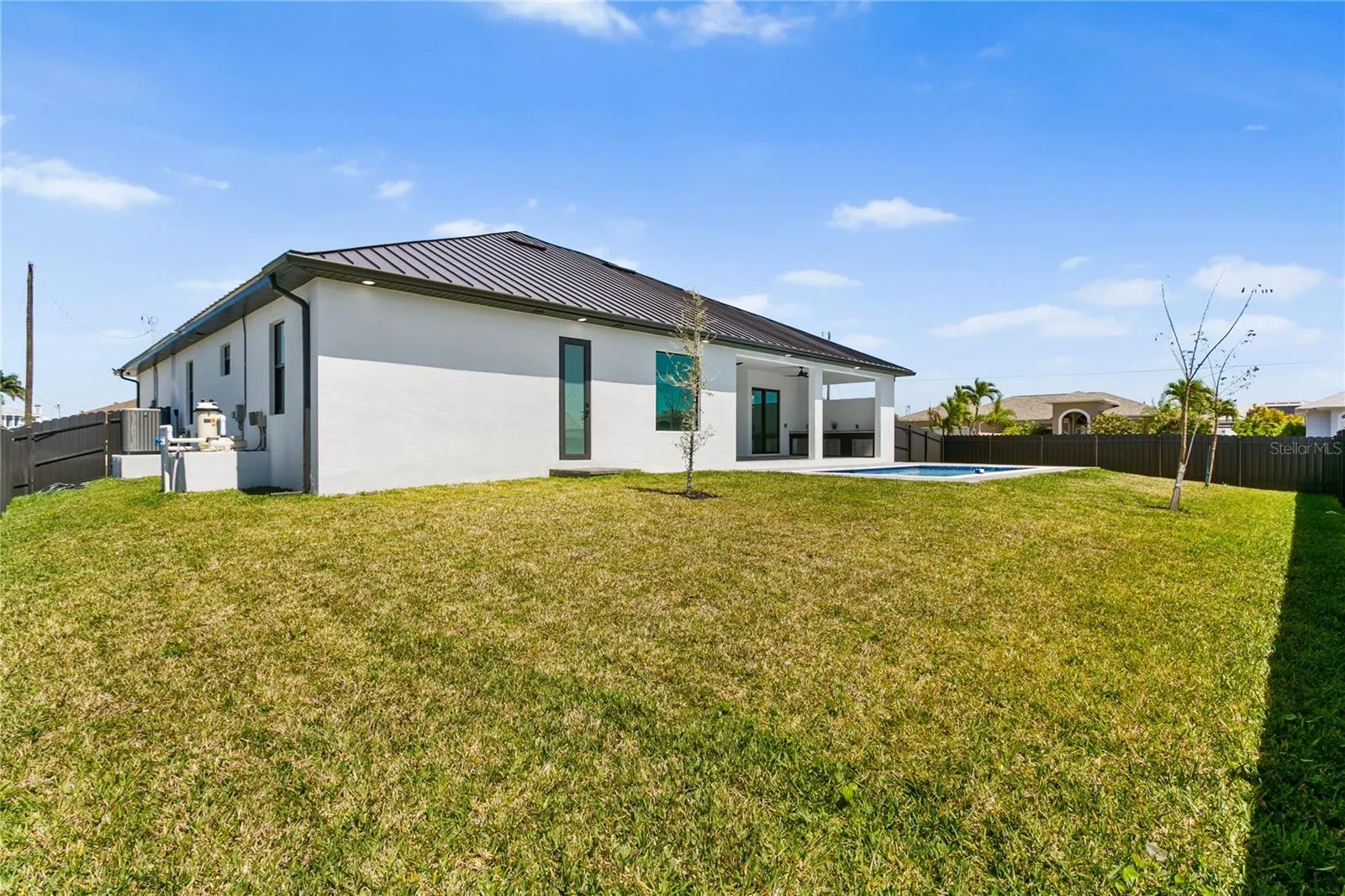 Spacious backyard offers plenty of room for a boat, trailer, or to create your own tiki retreat while providing ample space for pets to run and entertain outdoors.