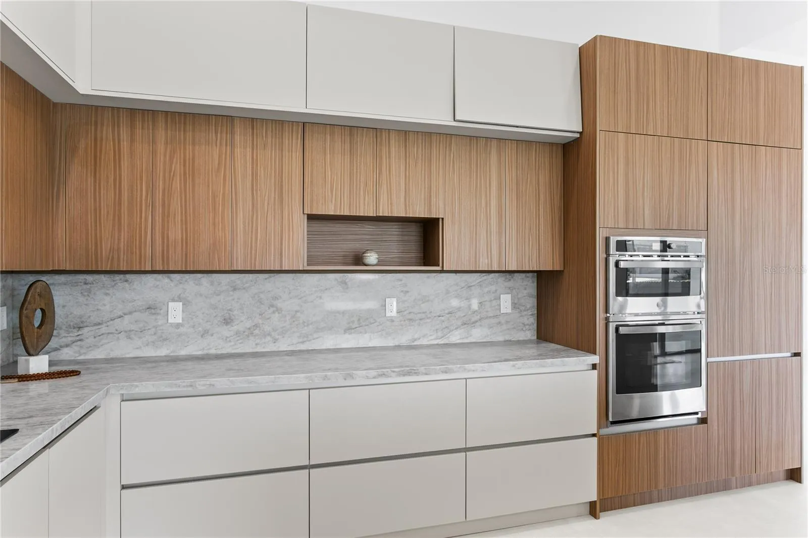 Large pantry & premium GE appliances including wall oven, microwave, electric cooktop, dishwasher, refrigerator and freezer, plus a large sink with black fixtures